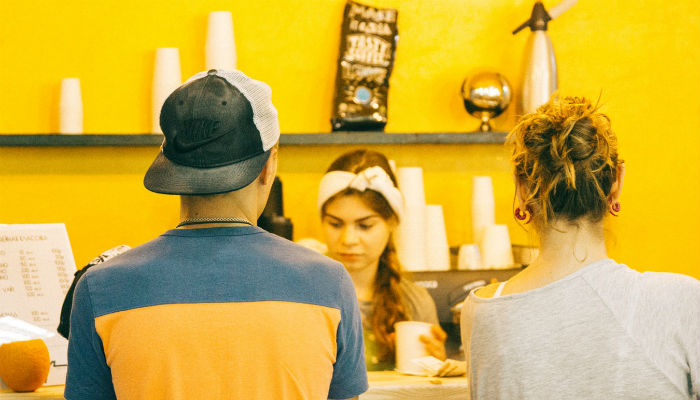 To personer der står i kø på en cafe